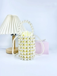 Handmade pearl bucket bag with gold accents, satin drawstring lining and crossbody chain