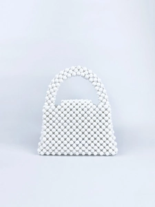 Detailed view of handmade white beaded handbag with faceted acrylic beads and curved handle