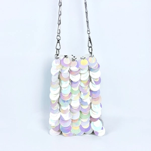 Detailed view of iridescent sequin crossbody bag with silver metal chain strap
