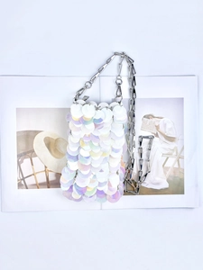 Close-up of iridescent sequins and silver chain strap on a stylish mini shoulder bag