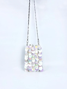 Detailed view of iridescent white sequins and silver metal chain on a mini crossbody bag