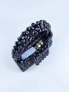 Detail view of the black beaded handbag interior showing storage capacity for essentials