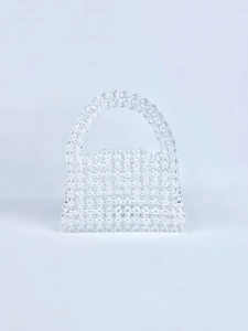 Macro detail of hand-woven clear beaded handbag with faceted crystal acrylic textures