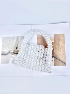 Detailed view of handmade transparent beaded handbag with faceted crystal-like beads