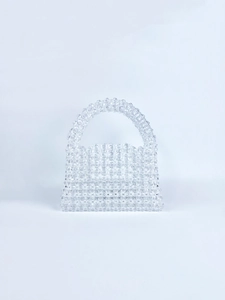 Detailed view of handmade beaded handbag with transparent crystal-like beads in square shape