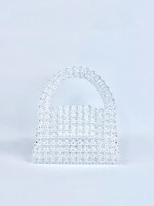 Detail showing hand-woven crystal beads texture on a transparent square evening handbag