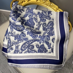 Elegant satin square silk scarf with blue paisley print on vintage white background