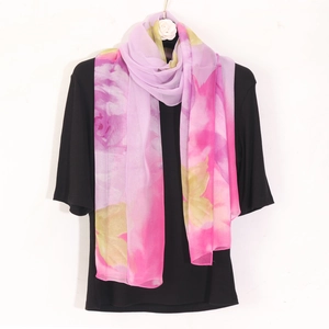 Detail of floral chiffon scarf with pink gradient and breathable lightweight fabric