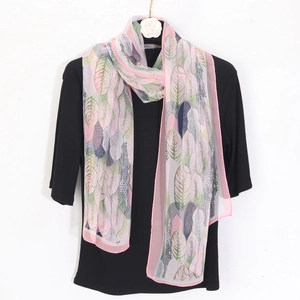 Floral chiffon scarf with pink and purple leaf patterns on a black ribbed shirt