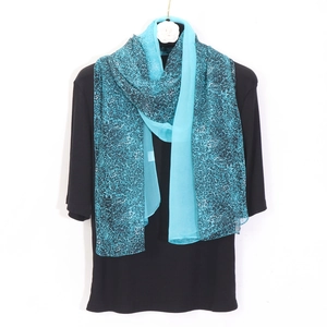 Close-up of tiffany blue leopard print chiffon scarf with breathable lightweight texture