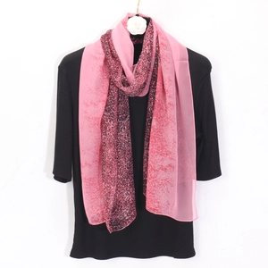 Detail view of pink leopard print georgette scarf on a mannequin with camellia