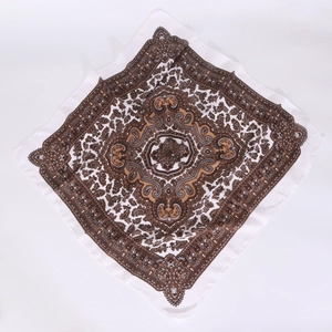 Detail shot of vintage paisley patterned cotton-linen square scarf with brown floral design