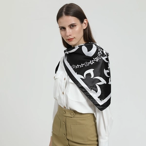 Carré de soie satiné noir et blanc à motif floral porté en châle élégant pour femme