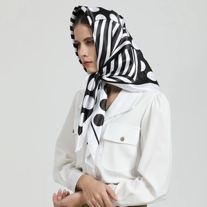 Détail d'un foulard en soie noir et blanc porté comme un foulard de style français
