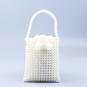 Handmade pearl beaded tote bag with satin lining and bow detail in a vintage French style