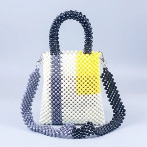 Detailed view of handmade beaded tote with geometric white, yellow and grey color blocking