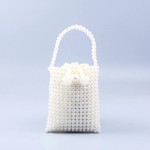Detail of white handmade pearl beaded handbag featuring drawstring satin inner lining