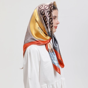 Detail of silk satin scarf with houndstooth print worn as a stylish headscarf
