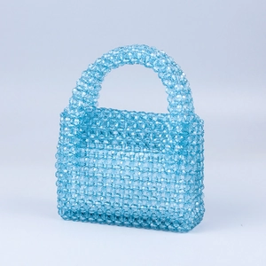 Detailed view of hand-woven light blue acrylic beaded handbag with faceted jelly texture