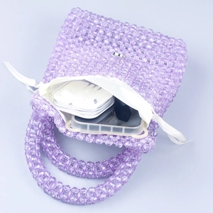 Top view of handmade purple beaded handbag showing interior lining and storage capacity