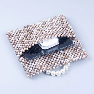 Handmade marble beaded bag with pearl handle showing interior space for phone