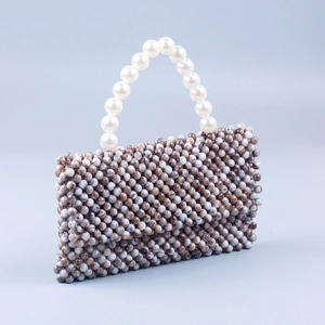 Detail of handmade beaded bag featuring marble texture beads and white pearl top handle
