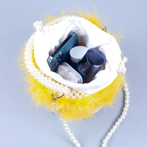 Fashionable bright yellow feather bucket bag with white pearl strap and drawstring closure