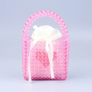Detailed view of pink beaded handmade handbag with white drawstring inner silk pouch