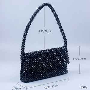 Detail shot of black beaded handbag with dimensions 27x14x5cm and handle height 22cm