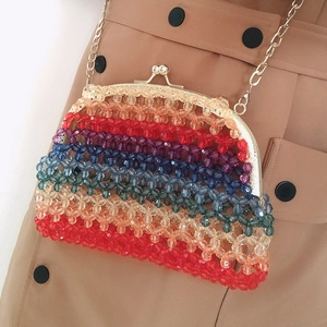 Detail of colorful handmade rainbow beaded crossbody bag with gold metal frame clasp