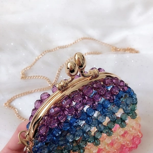 Detail of colorful rainbow gradient beaded bag with vintage gold metal clasp and chain