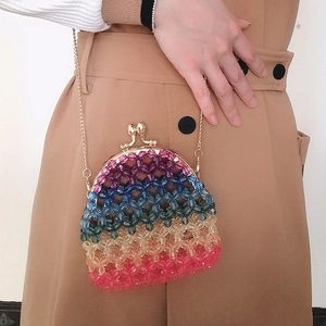 Detail view of handmade rainbow beaded acrylic mini bag with golden kiss-lock clasp