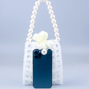 Handmade clear acrylic beaded handbag with large white pearl handle and satin ribbon bow