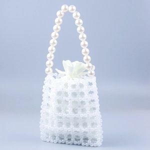 Elegant woven acrylic grid handbag with faux pearl handles and a white satin drawstring pouch