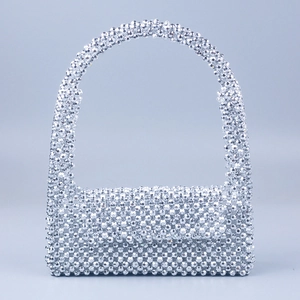 Detail of silver beaded handbag with handcrafted metallic acrylic round beads and flap cover