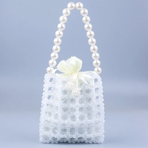 Detail of beaded handbag with white lattice pattern, satin drawstring and pearl handle