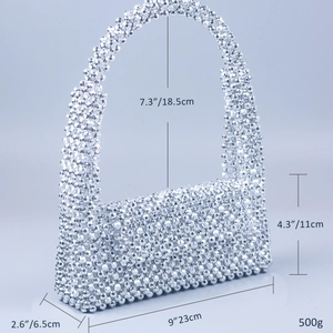Detail view of silver beaded woven handbag showing sizes 23x6.5x11cm and metallic texture