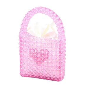 Handmade pink beaded tote bag with heart pattern and white satin drawstring pouch