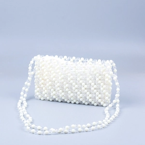 Close-up of handmade beaded bag with cream white and transparent acrylic wave texture