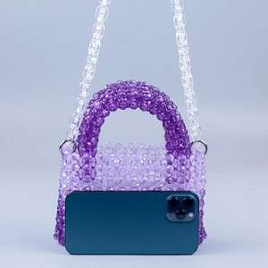 Detail of purple gradient acrylic beaded handbag with transparent plastic chain strap