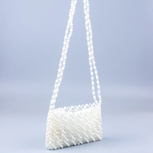 Handmade beaded shoulder bag with white and clear acrylic beads in a wave stripe pattern