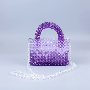 Close-up of gradient purple acrylic beaded handbag with round handle and transparent chain