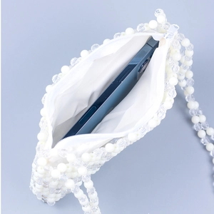 Handmade beaded shoulder bag with white and clear beads showing interior phone storage
