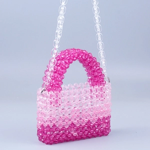 Macro shot of gradient pink acrylic bead weaving and transparent chain handle detail