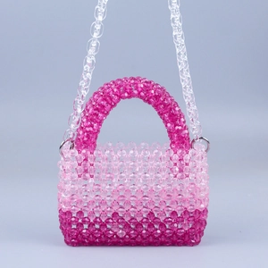 Detail of pink gradient beaded handbag featuring round acrylic beads and a chunky chain strap