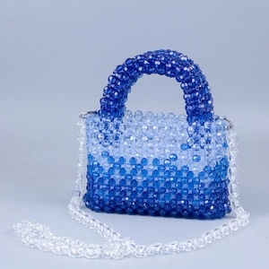 Detail of gradient blue acrylic beaded bag with clear chain and manual weave texture