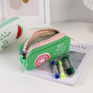 Macro detail of high-capacity fruit canvas pencil case with oversized pink zipper teeth