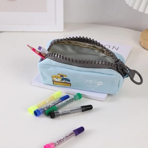 Detail of light blue canvas pencil case with thick grey plastic zipper and cartoon dogs