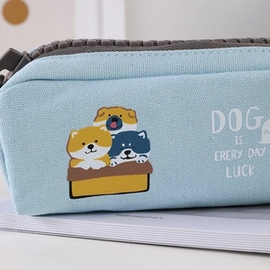 Close-up of light blue canvas pencil case featuring a large grey zipper and cute shiba inu print