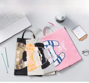 Detailed top view of four A4 cat-themed oxford cloth document bags on a desk